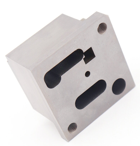 Tooling insert with a shaped internal slot and mounting holes