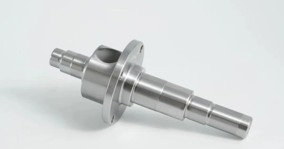 Stepped shaft with multiple journals, shoulders, and a central flange