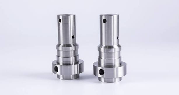 Two stepped cylindrical shaft bodies with transverse holes and side features