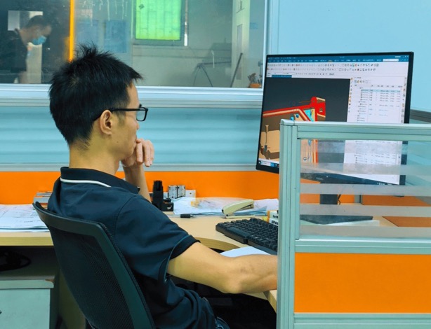 Plyconn engineer reviewing a component design in the factory office