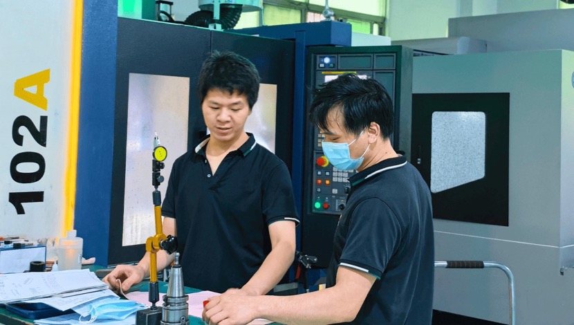 Plyconn machinists checking a setup together on the production floor